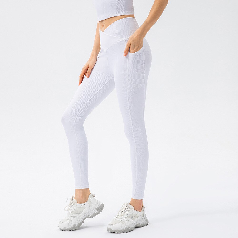 a women wearing white leggings and a crop top
